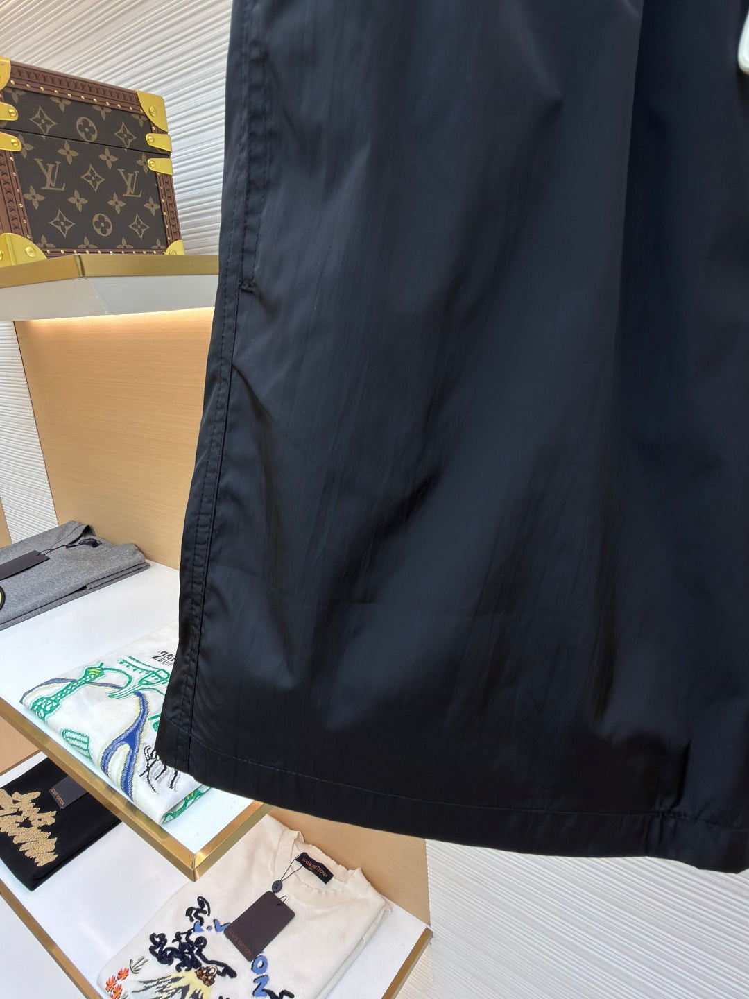 Moncler dark navy swim shorts side view with textured hem and stitched seam