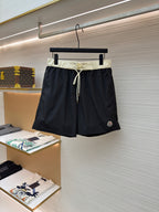 Moncler dark navy swim shorts with pale drawstring waist and side pockets