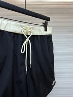 Moncler dark navy swim shorts front view with pale drawstring and loop detail