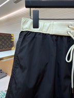 Moncler dark navy swim shorts with pale waistband and white drawstring ends