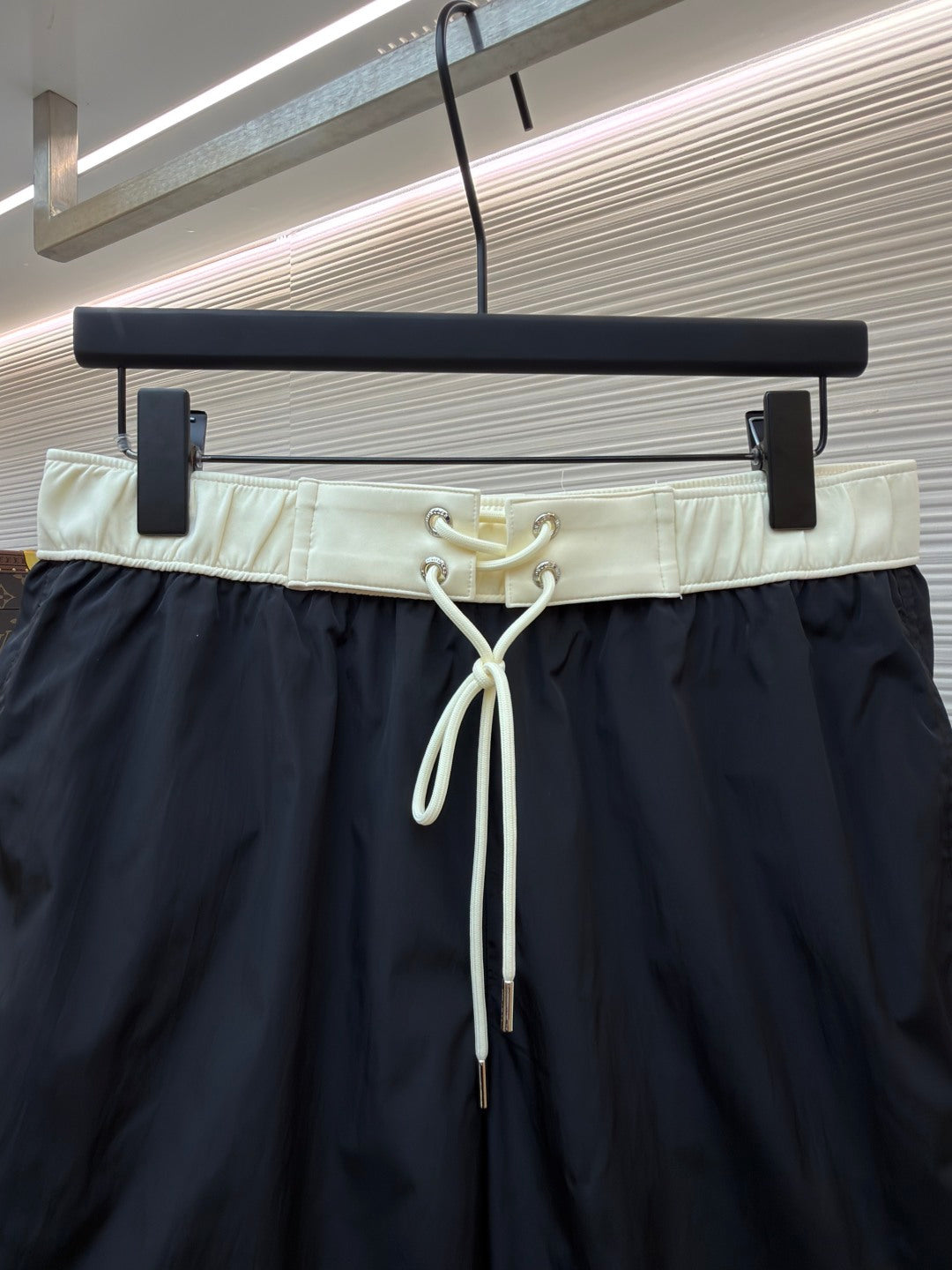 Moncler dark navy swim shorts close-up of pale elastic drawstring waist