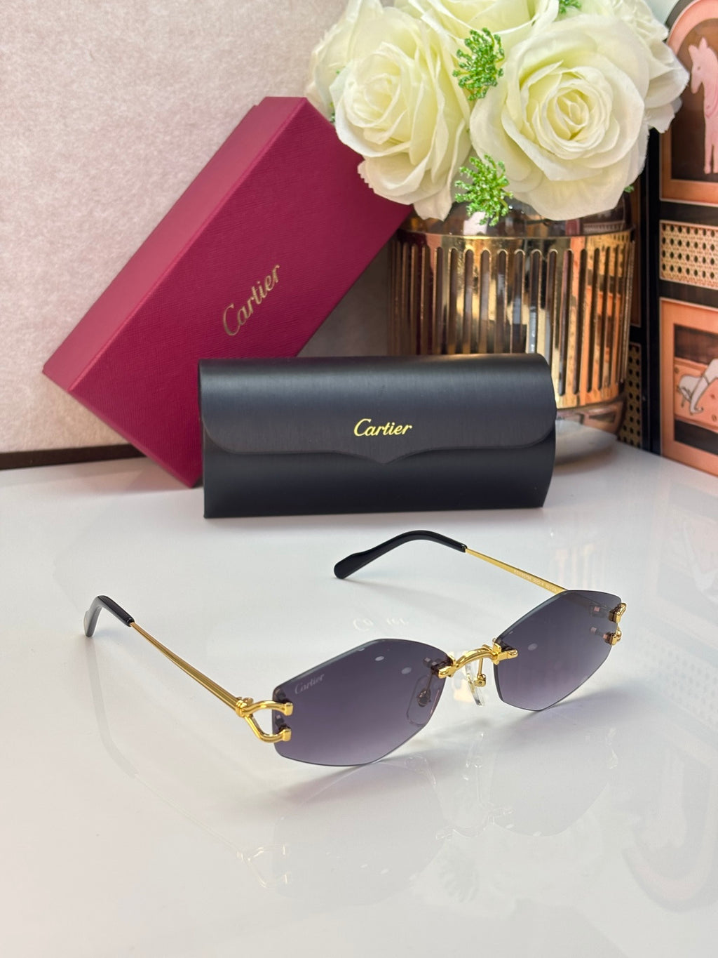 Gold metal sunglasses with purple lenses and black temple tips, angled view