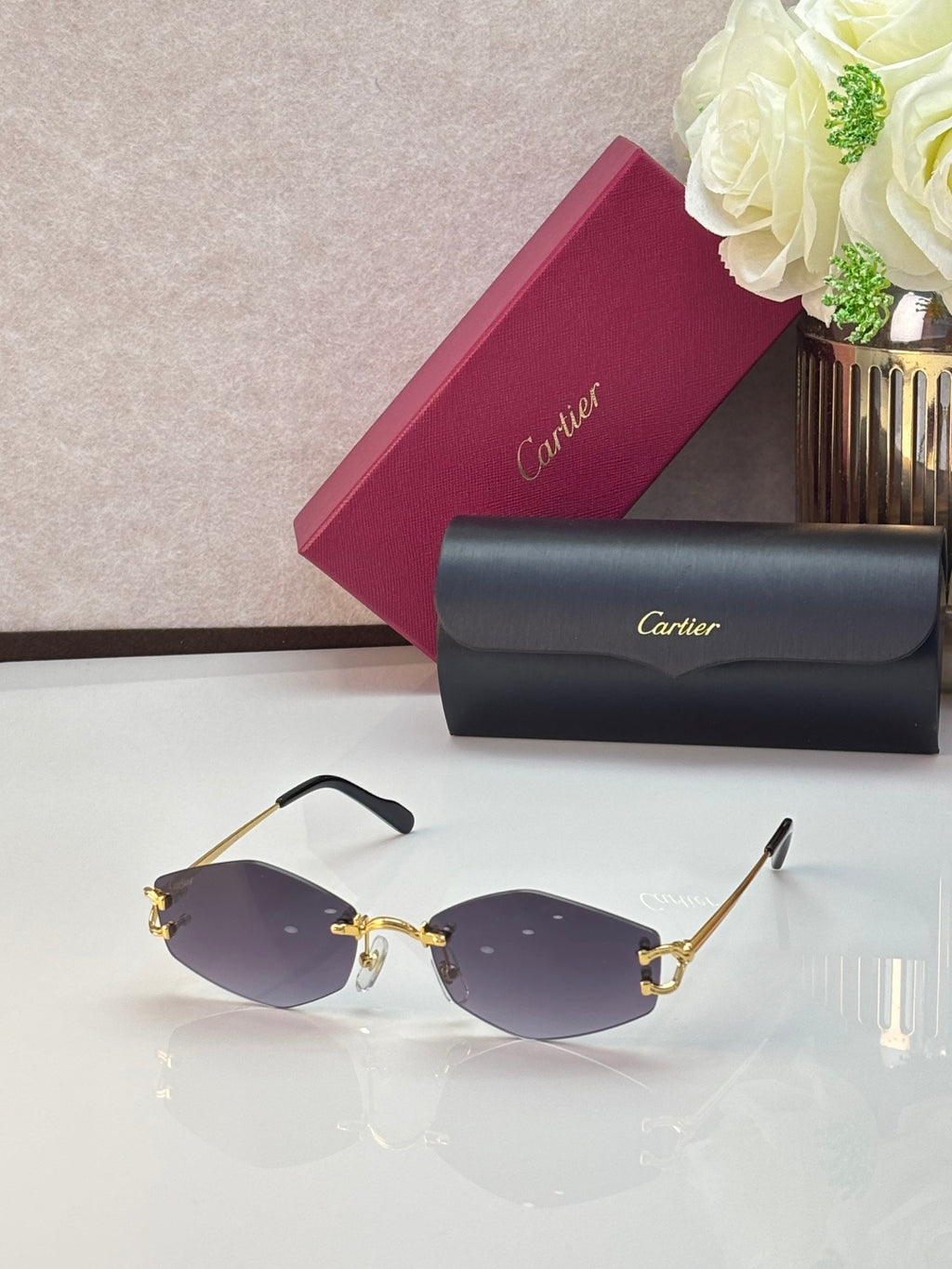 Gold metal sunglasses with dark purple lenses and black temple tips