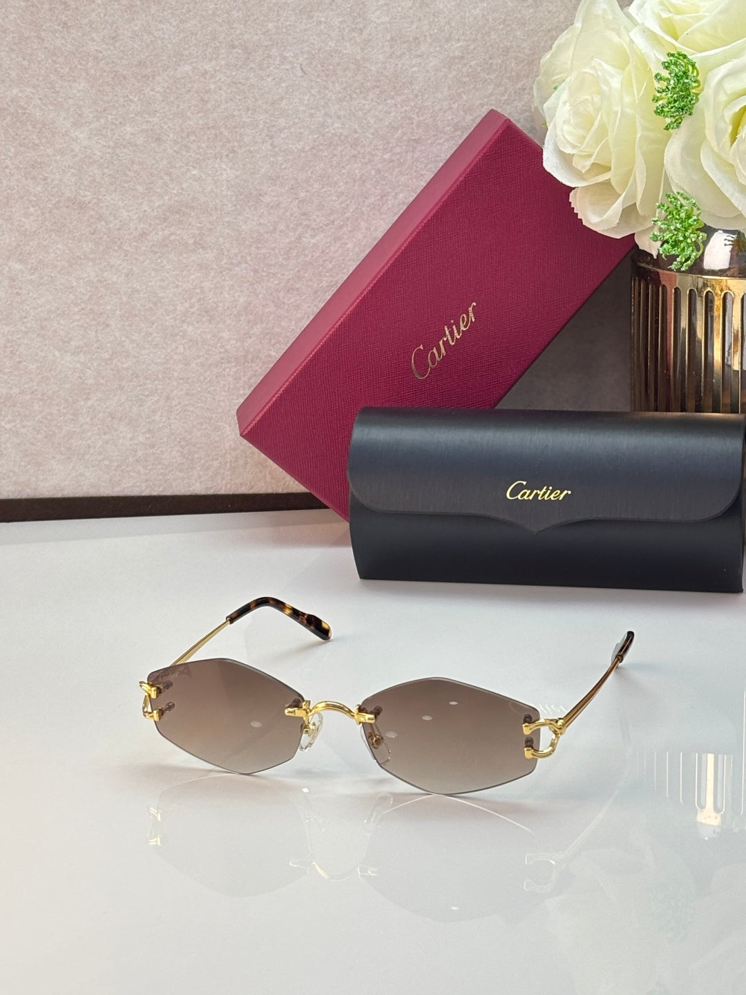 Gold metal sunglasses with pale rose lenses and gold temple details
