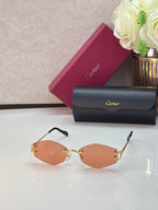 Gold metal sunglasses with orange-tinted lenses and thin gold temple arms