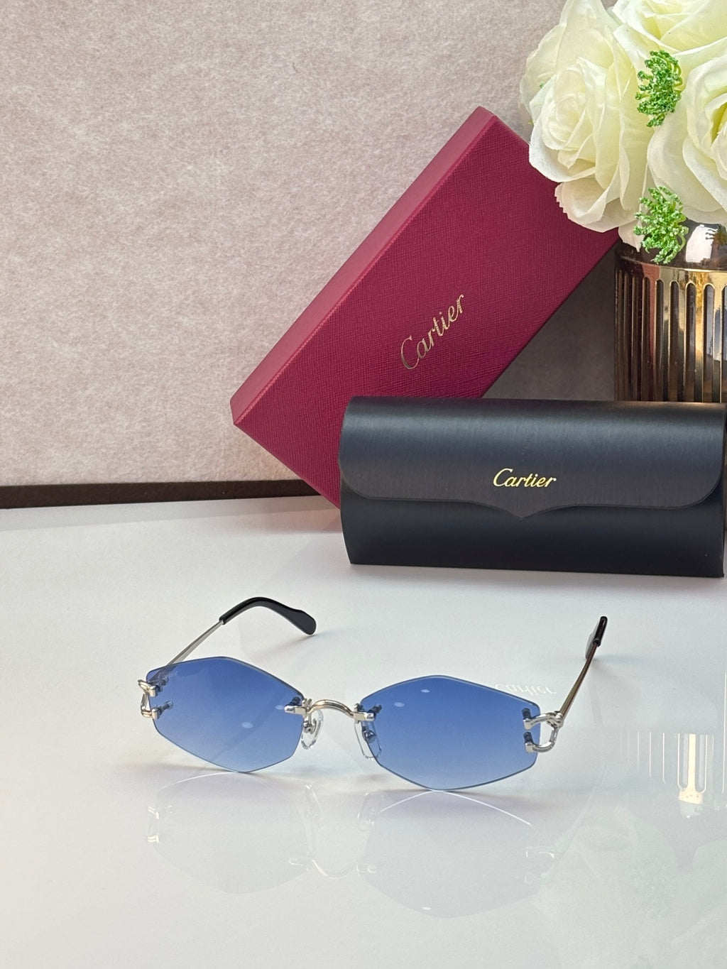 Gold metal sunglasses with blue-tinted lenses and black temple tips