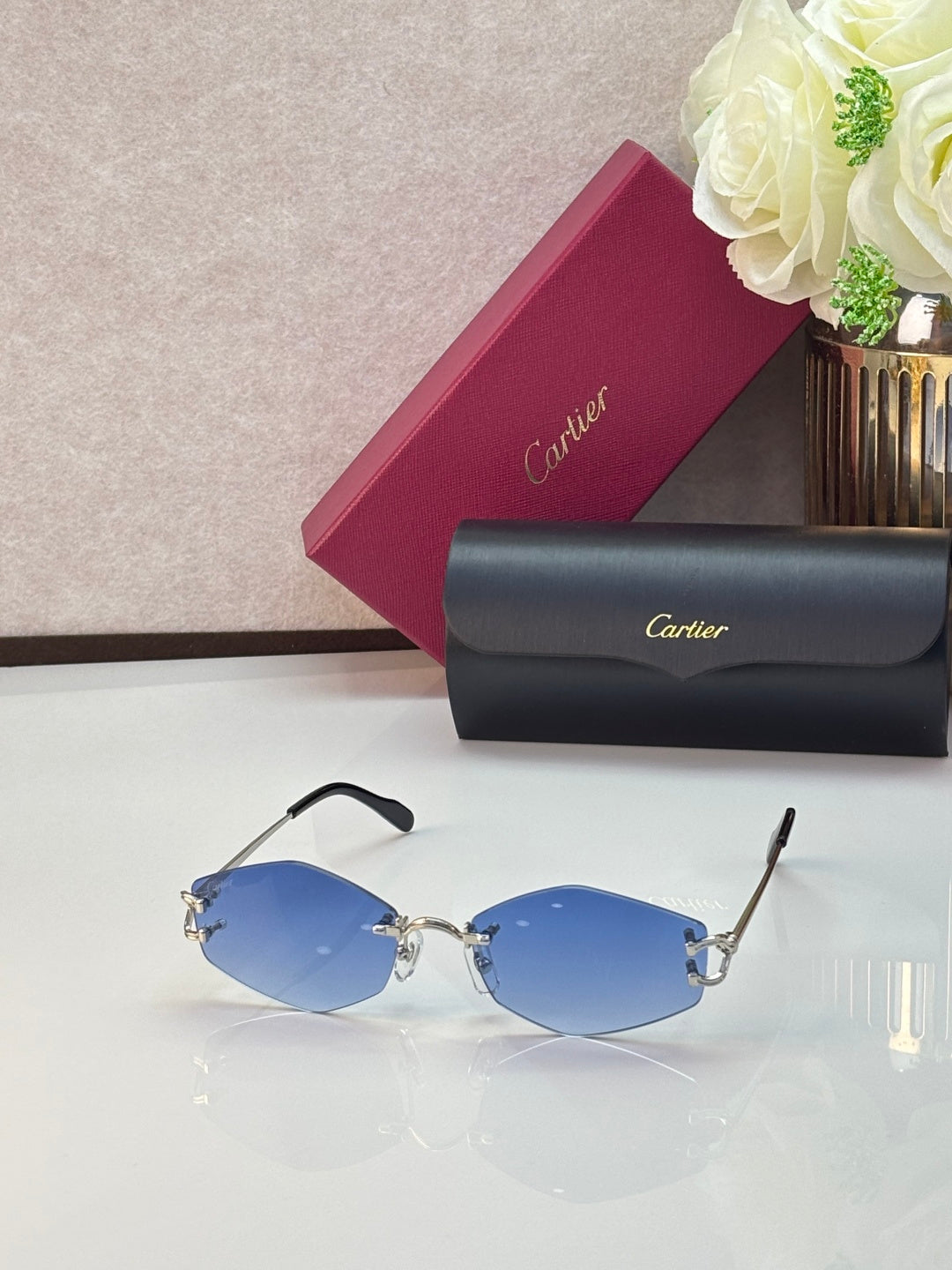 Gold metal sunglasses with blue-tinted lenses and black temple tips
