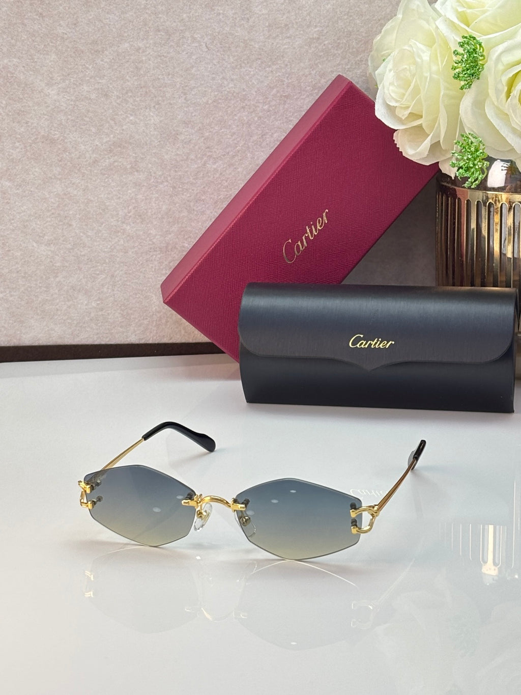 Gold metal sunglasses with light blue lenses and gold decorative details