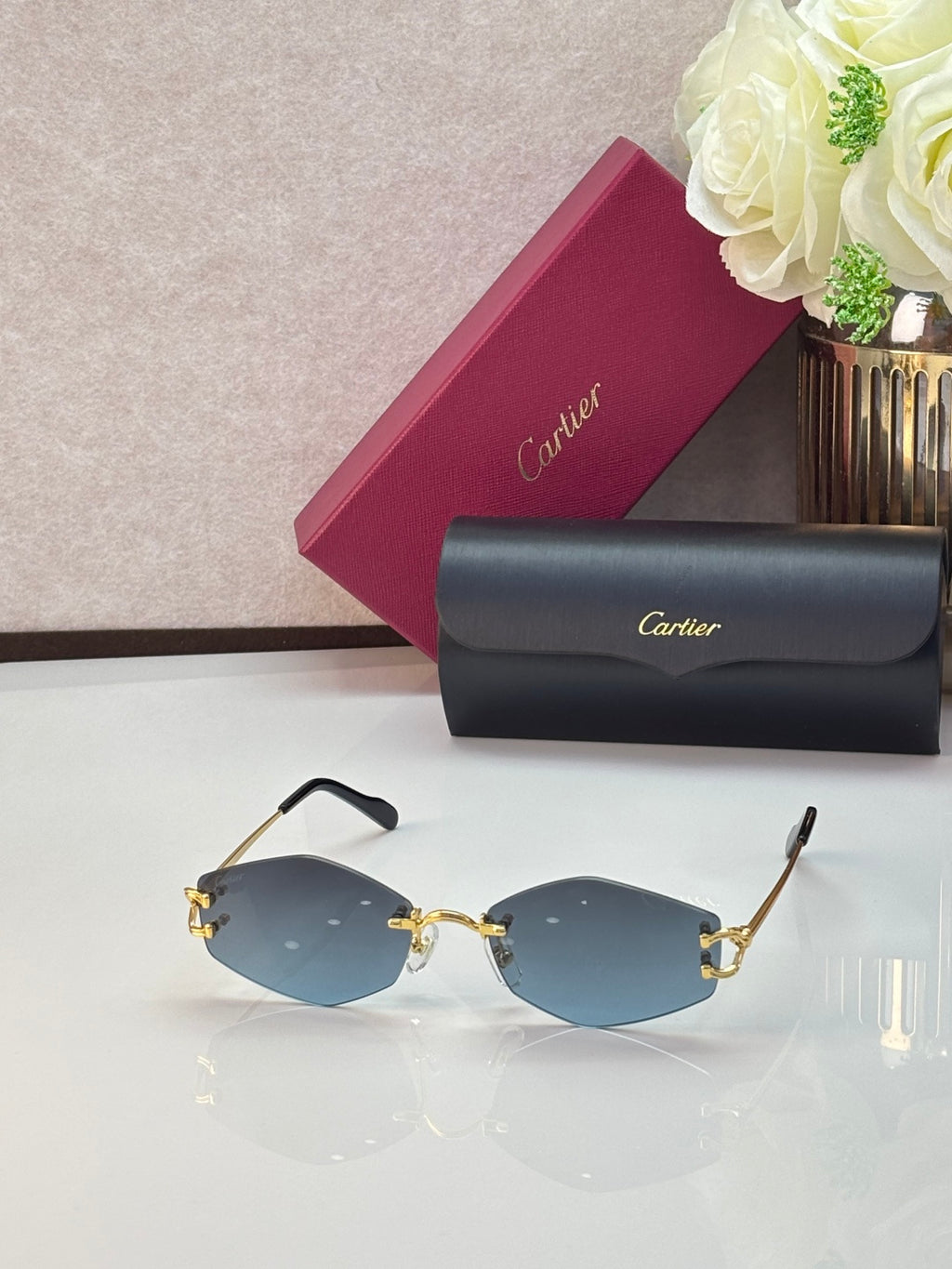 Gold metal sunglasses with blue-tinted lenses and thin gold temple arms