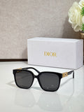 Black sunglasses with gold logo hardware and dark lenses