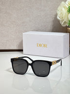 Black sunglasses with gold logo hardware and dark lenses