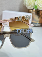 Sunglasses close-up with DIOR logo temples and dark lenses