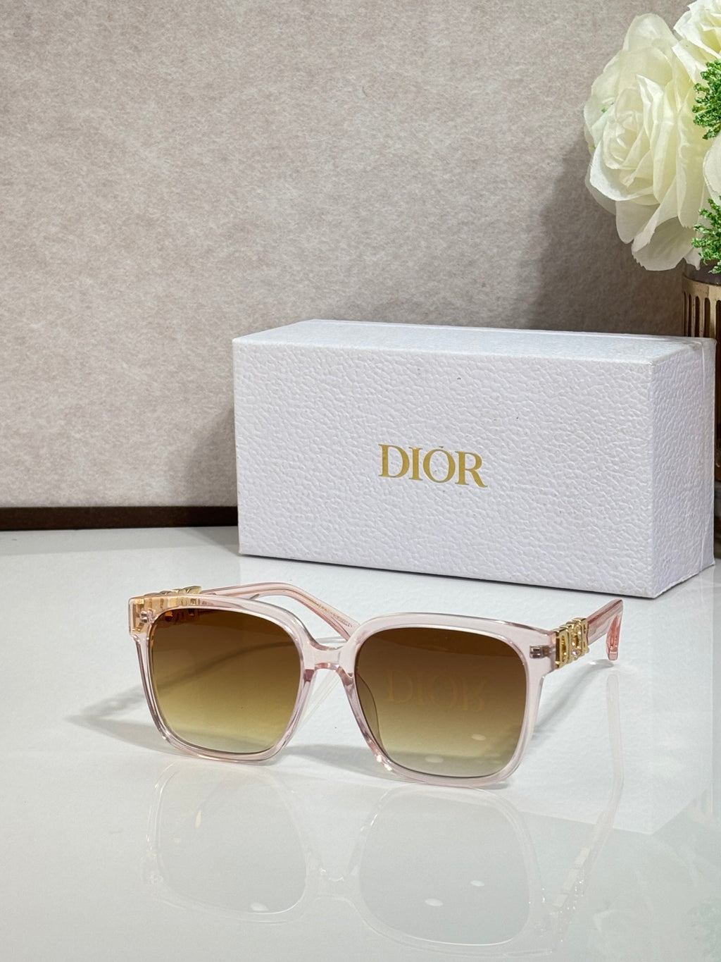 Rose sunglasses with gold logo hardware and tinted light-brown lenses