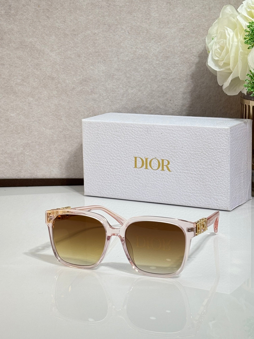 Rose sunglasses with gold logo hardware and tinted light-brown lenses