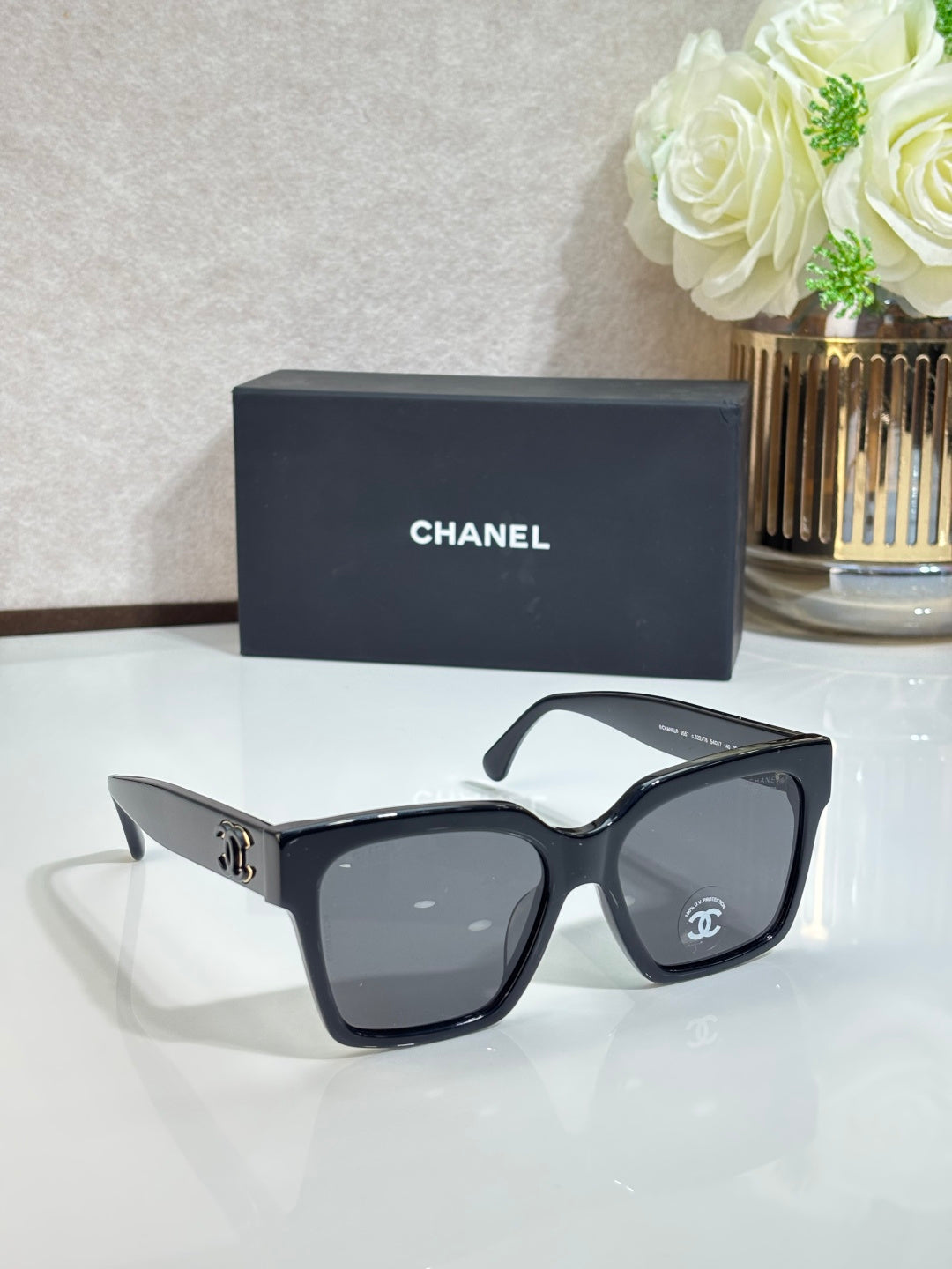 Sunglasses with black frames and gray tinted lenses, side view