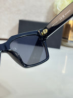 Sunglasses with dark blue frames and gray tinted lenses, close-up