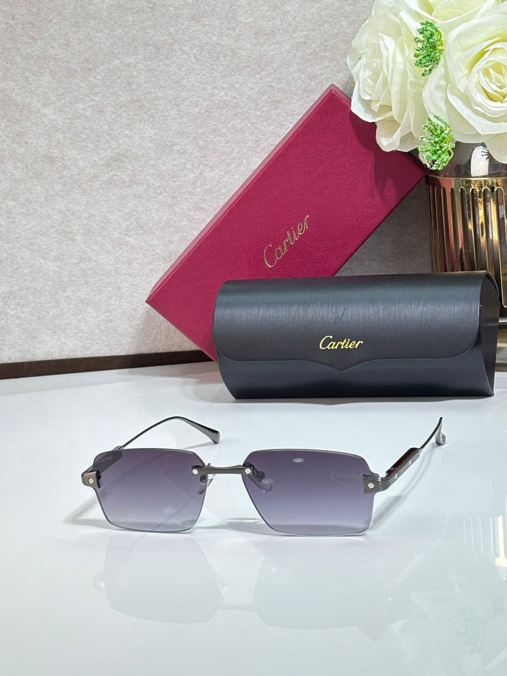 Sunglasses with purple lenses, metal frame, and gray case