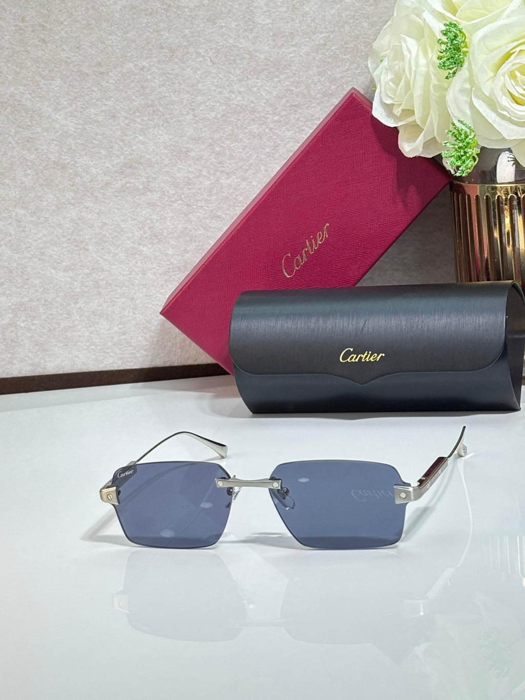 Sunglasses with blue lenses, metal frame, and gray case