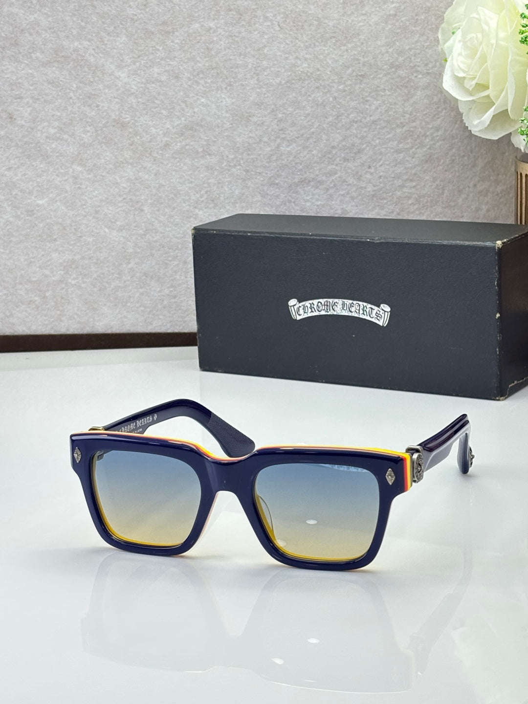 Chrome glasses with dark blue lenses and black frames, square-rectangular shape