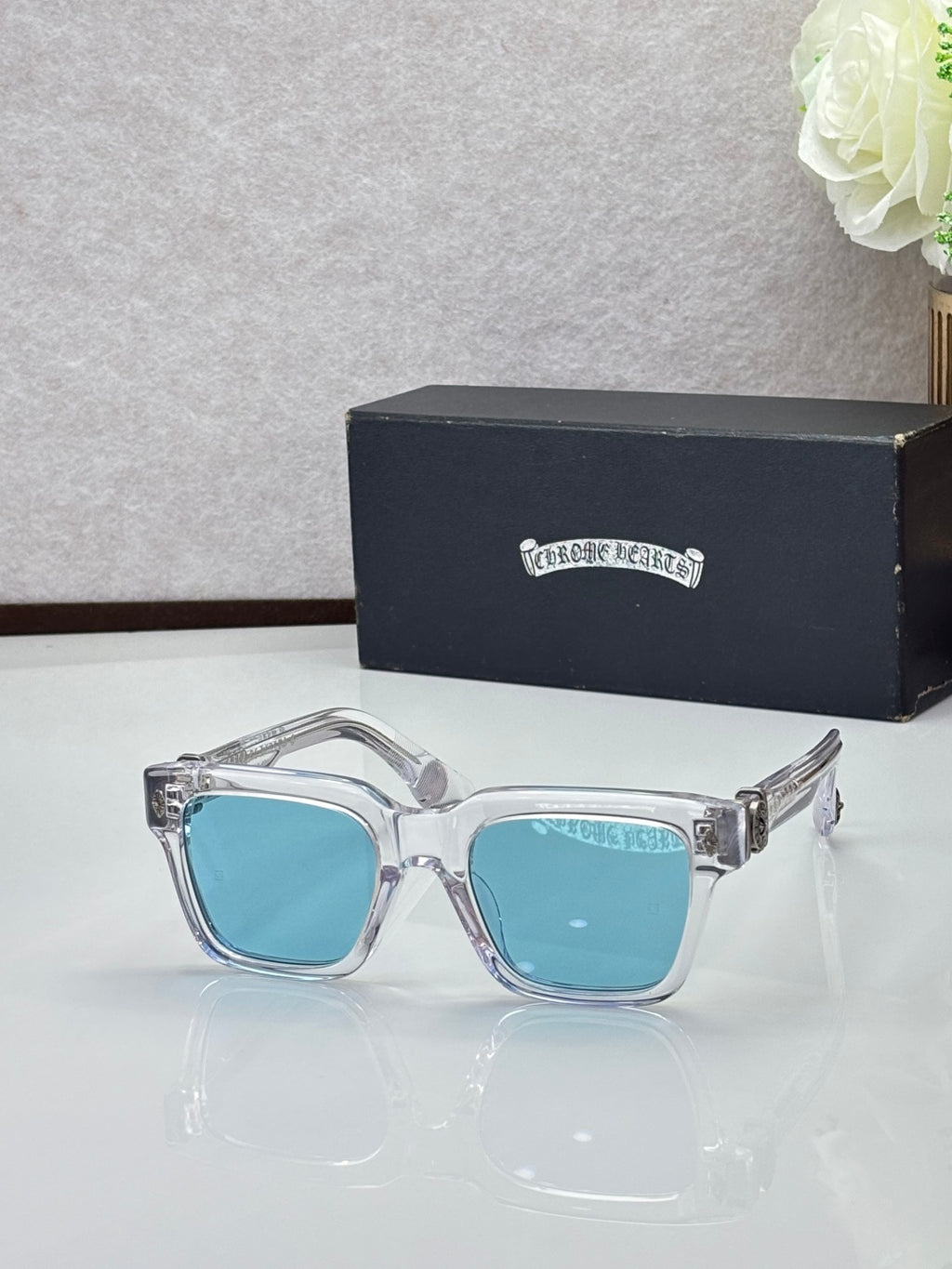 Chrome glasses with clear frames and light blue lenses, square-rectangular shape