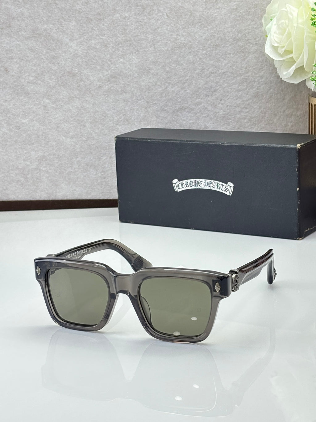 Chrome glasses with black frames and greenish lenses, rectangular shape