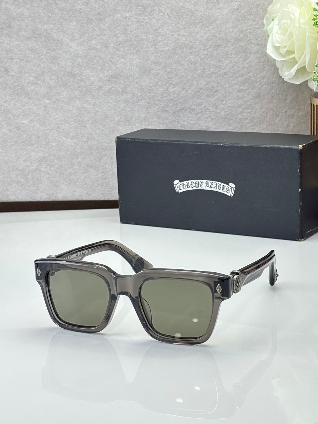 Chrome glasses with black frames and greenish lenses, rectangular shape