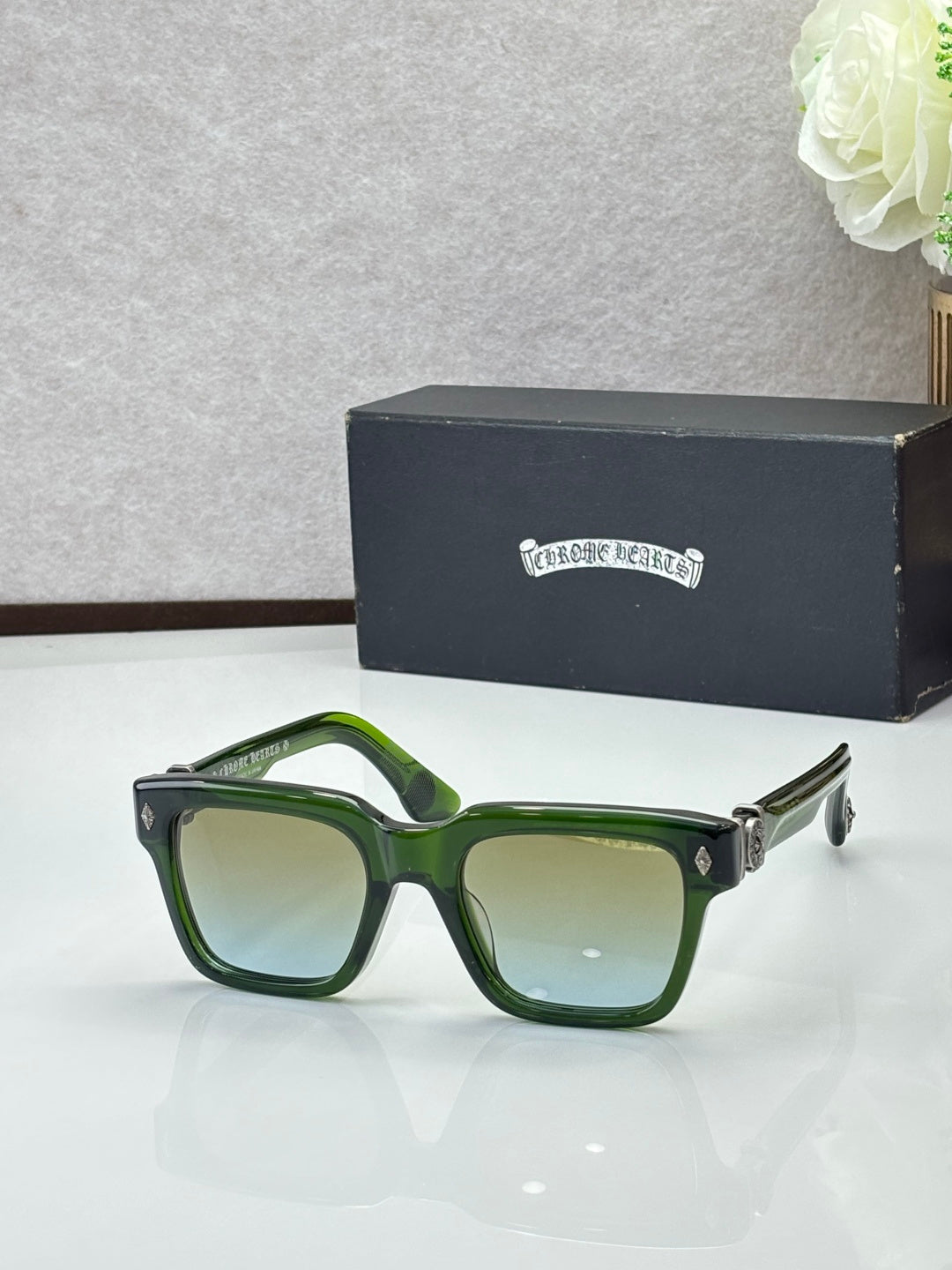 Chrome glasses with dark frames and green lenses, square-rectangular shape