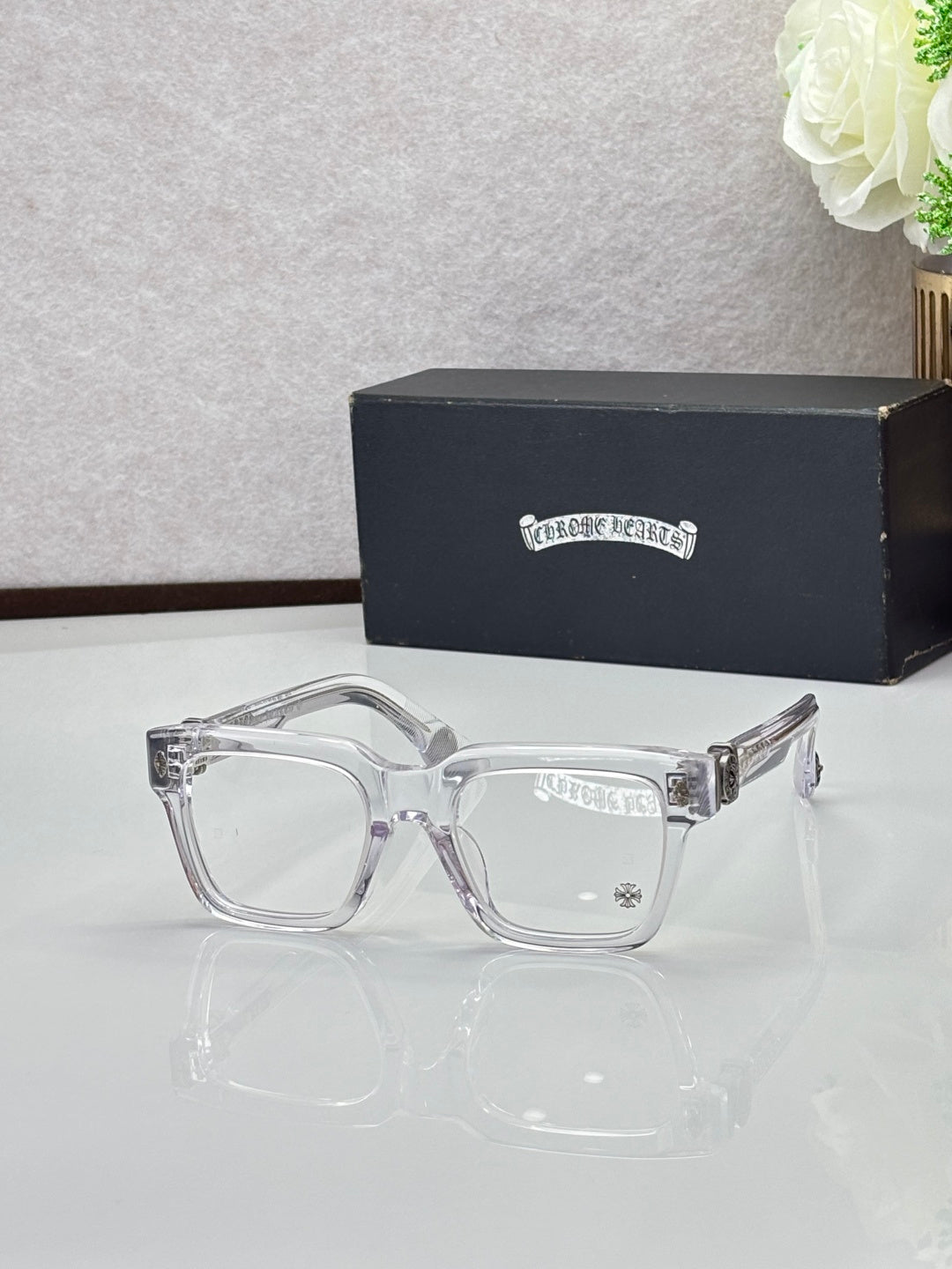 Clear acetate eyeglasses with square frames, metal hinges and clear lenses