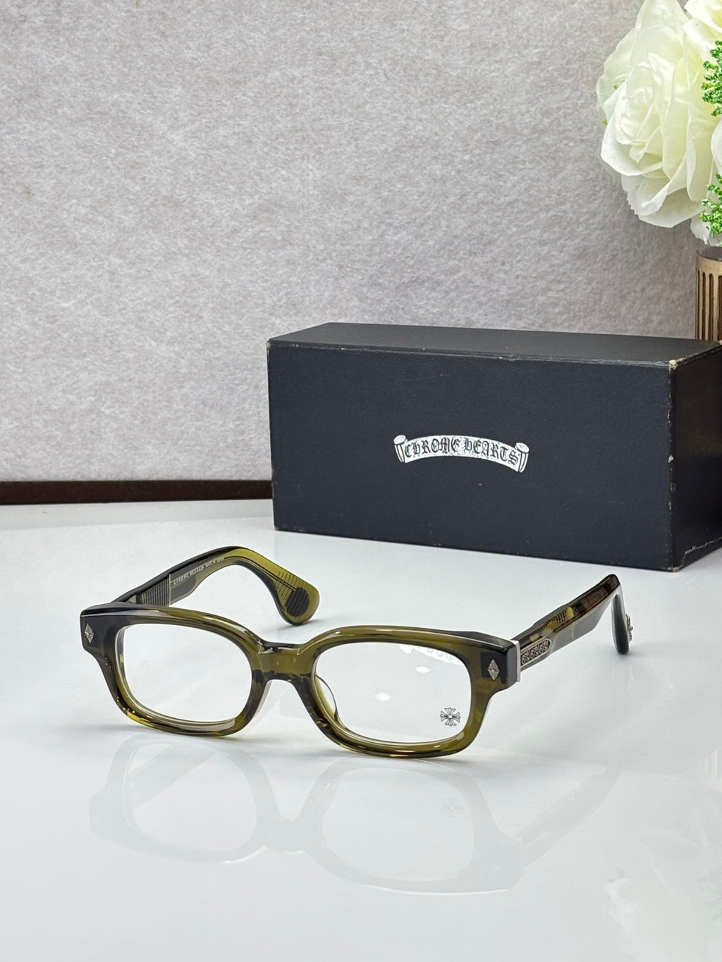 Olive green oval glasses with clear lenses and gold temple accents