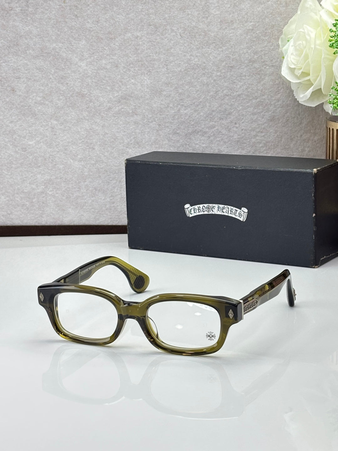 Olive green oval glasses with clear lenses and gold temple accents