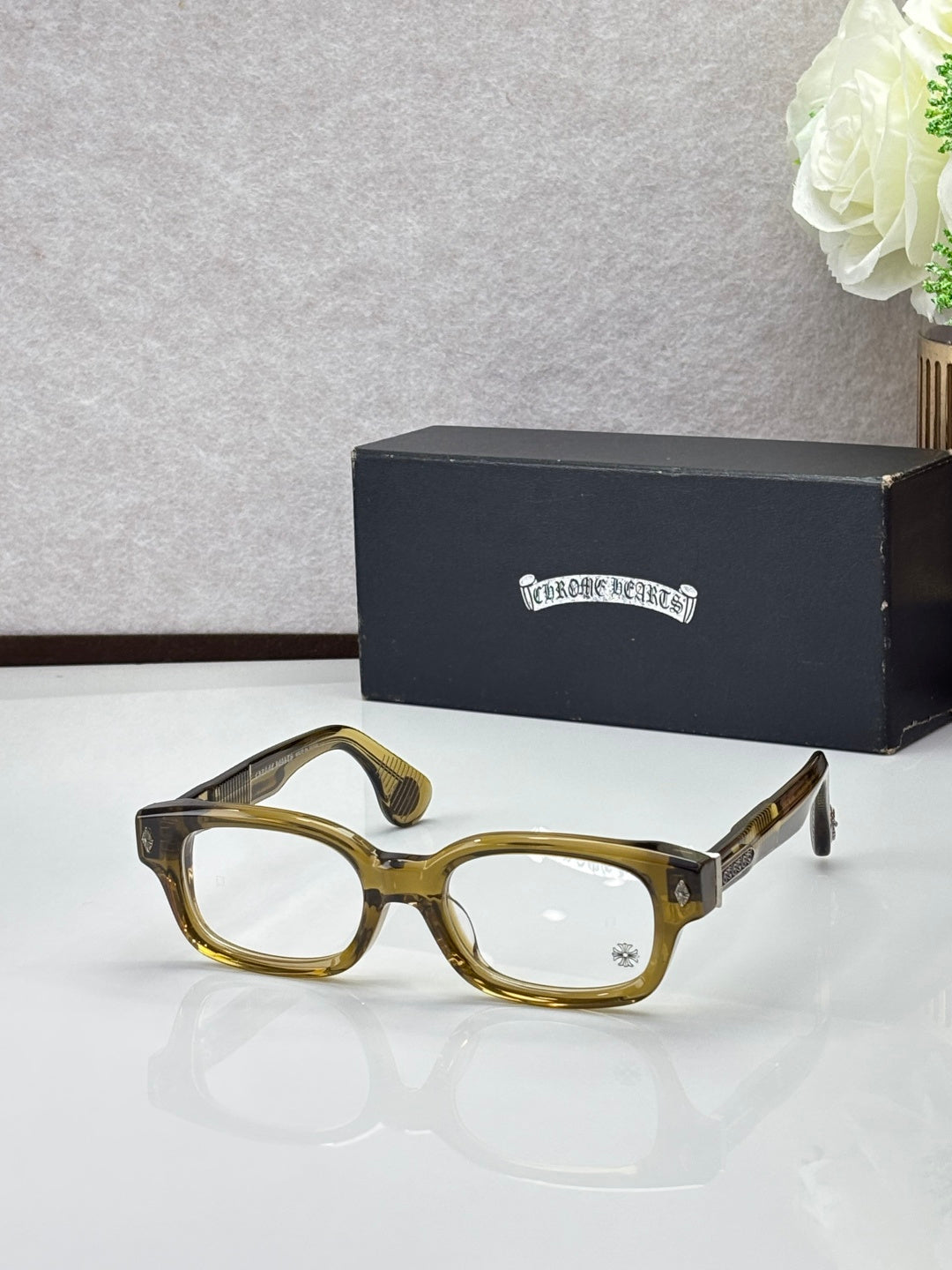 Olive green oval glasses with clear lenses and gold temple detail