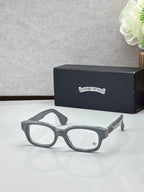 Gray oval glasses with clear lenses and gold temple detail