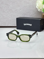 Black oval sunglasses with light green lenses and green-tinted temple accents