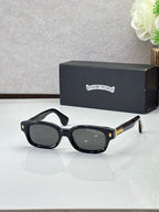 Black oval sunglasses with dark lenses and gold detail on the temples