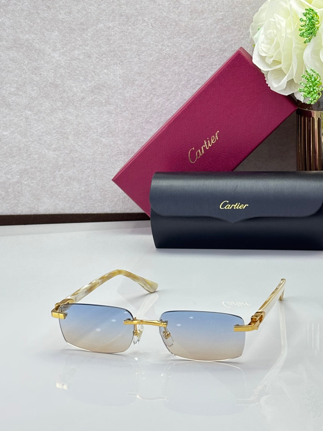 Cartier glasses, gold frames with light blue gradient lenses and gold-tone details