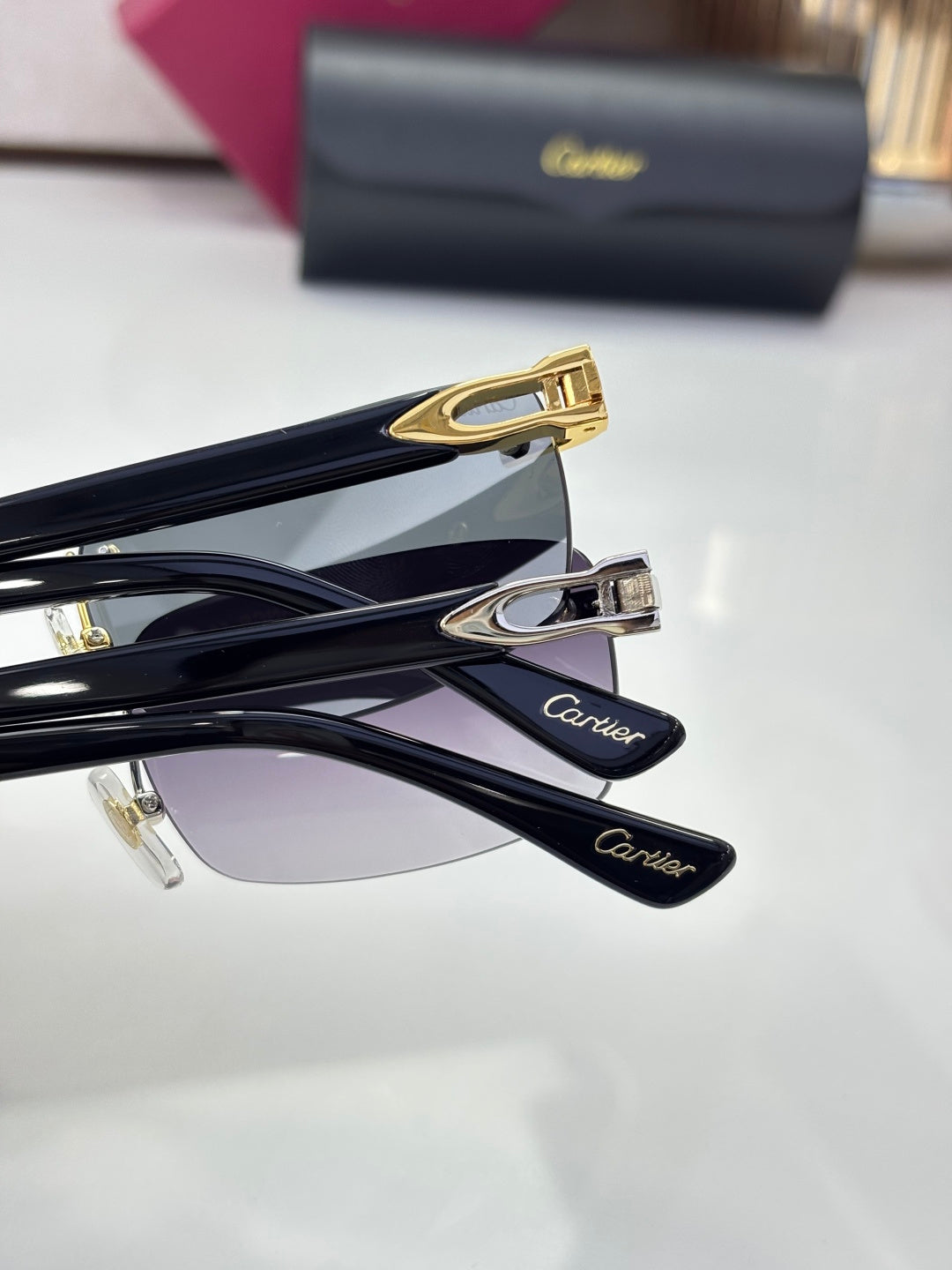 Cartier glasses close-up, black temples with gold hardware and engraved “Cartier” marks