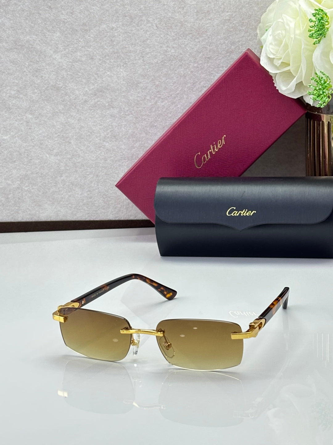 Cartier glasses, gold frames with amber lenses and gold-tone temple accents