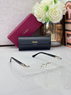 Clear rectangular eyeglasses with black temple arms and gold-tone bridge hardware.