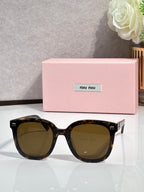 Dark tortoiseshell round sunglasses with olive-brown lenses and gold side emblems