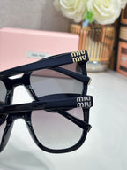 Navy acetate sunglasses with gold logo on temple and tinted lenses