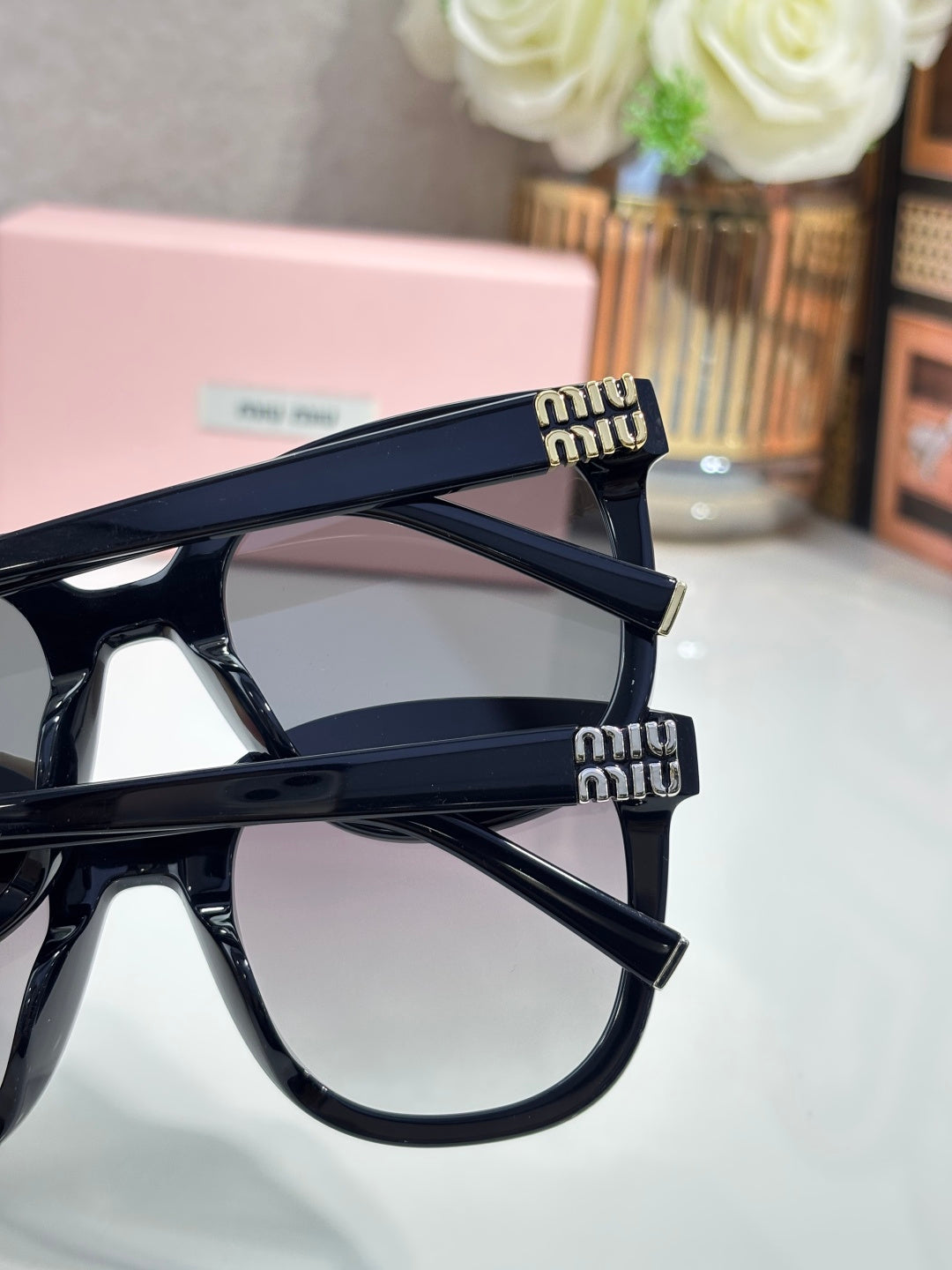 Navy acetate sunglasses with gold logo on temple and tinted lenses