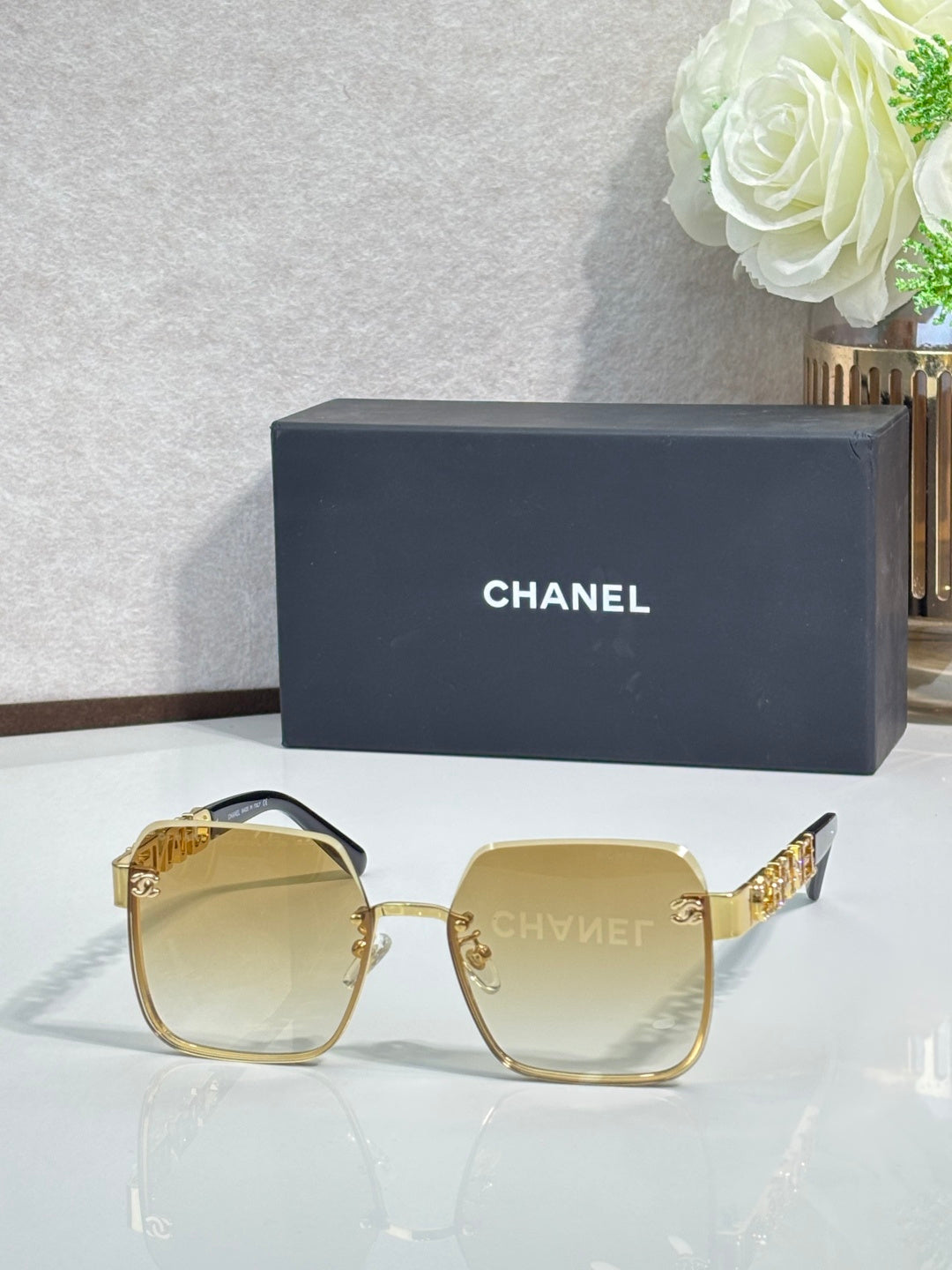 Chanel square sunglasses with light yellow tinted lenses and gold-tone frame