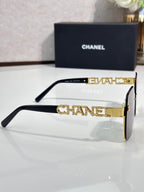 Chanel sunglasses side view with black frame and gold-tone temple lettering