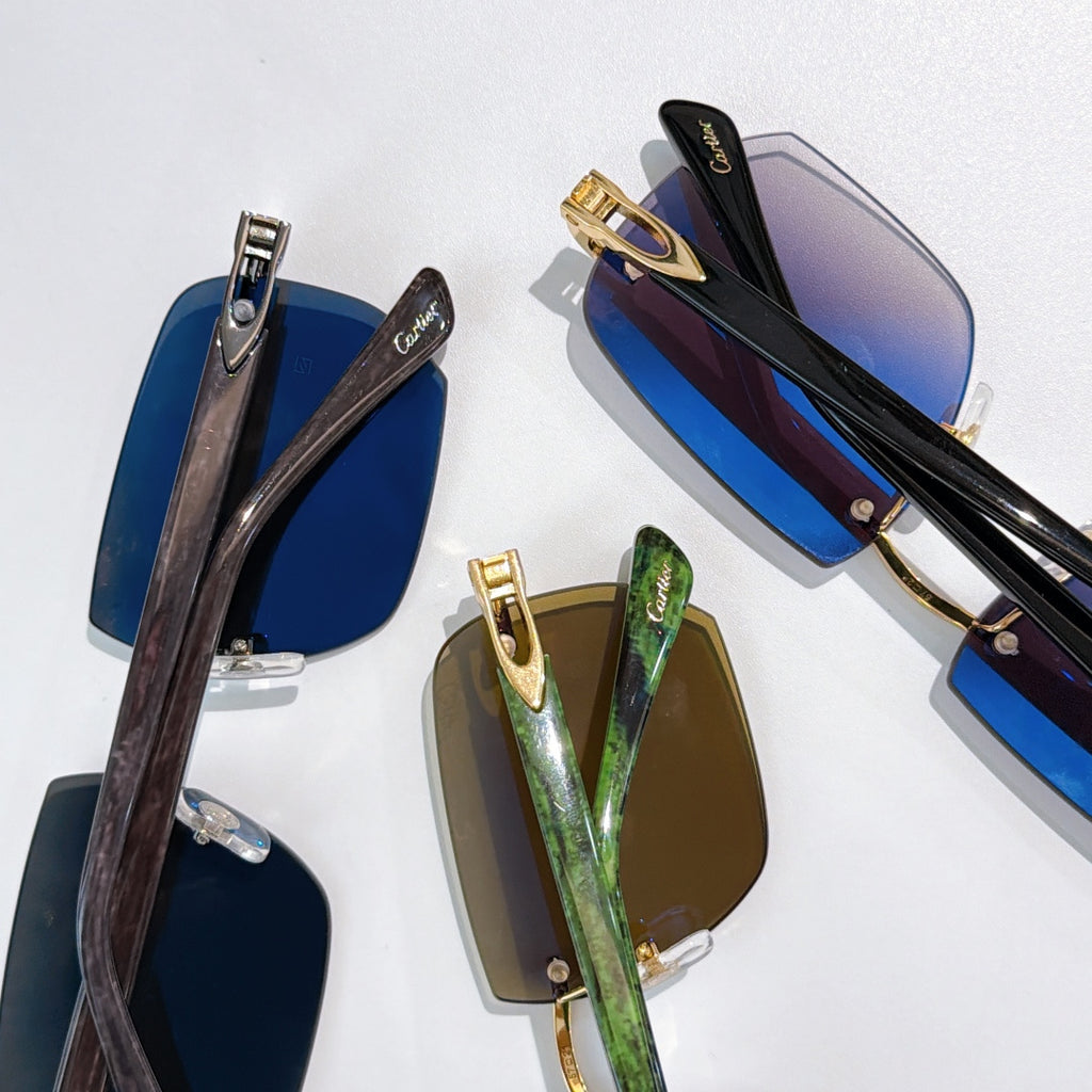 Cartier sunglasses with blue and green gradient lenses, gold-tone and dark frames