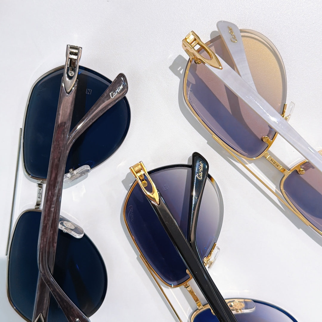 Sunglasses with gold accents and dark blue tinted lenses, overlapping angles