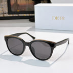 Dior cat-eye sunglasses with dark frames and tinted lenses, gold-tone accents
