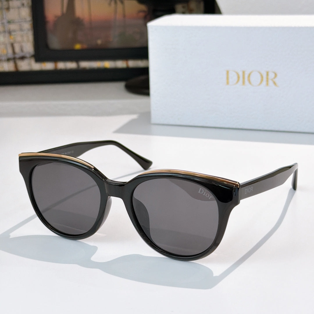 Dior cat-eye sunglasses with dark frames and tinted lenses, gold-tone accents