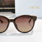Dior cat-eye sunglasses close-up with dark frames and rose-tinted lenses
