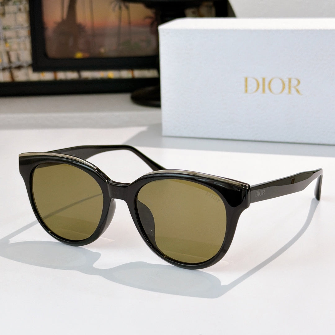 Dior cat-eye sunglasses with black frames and olive-tinted lenses, gold-tone accents