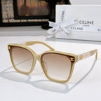 Sunglasses with cream frame and brown tinted lenses, gold logo on temples